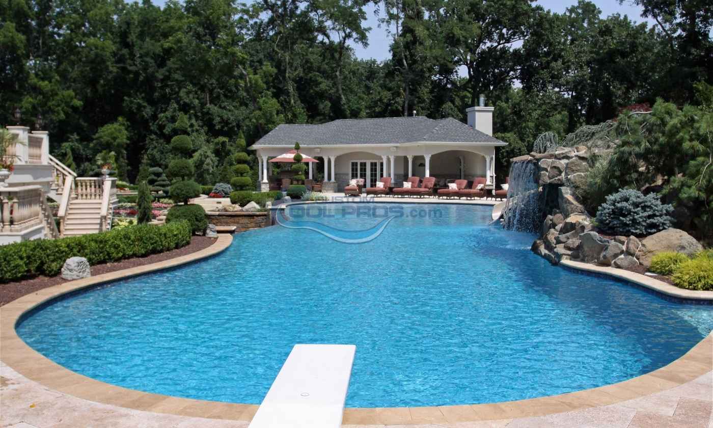 Luxurious residential swimming pool with a waterfall feature, surrounded by landscaped gardens and a cozy poolside gazebo. Perfect for outdoor relaxation and entertaining, luxury swimming pools, inground pools