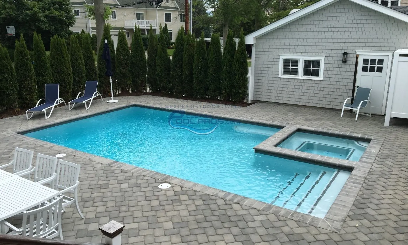 inground pool installation with square shaped spa and stairs